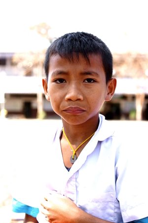 BAN BO NAM CHING, SA KAEW, THAILAND - February 10, 2014: Children eating, drinking and playing in the coutyard of a school in Ban bo nam ching, Sa kaew, Thailand.のeditorial素材