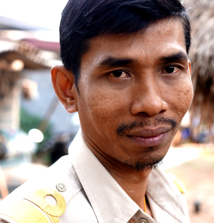 BAN BO NAM CHING, SA KAEW, THAILAND - February 12, 2014: A Thai government employee relaxing in the courtyard of his home in Ban bo nam ching, Sa kaew, Thailand.のeditorial素材