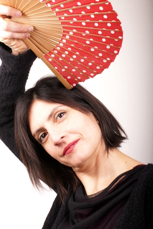 Woman with red fanの写真素材