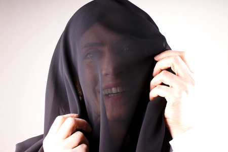 Woman with black trasparent scarfの写真素材