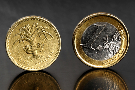 Studio shot of one euro coin and one pound coinの写真素材