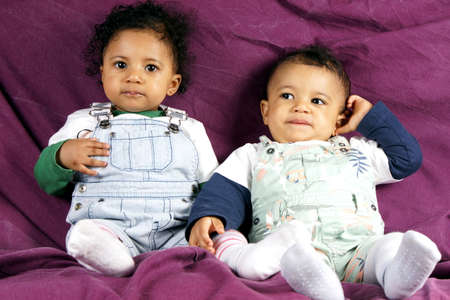 Studio shot of children on purple backgroundの写真素材