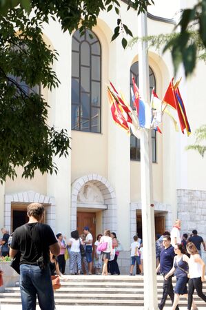 Medjugorje, Citluk, Bosnia and Herzegovina - August 14, 2015: Pilgrims strolling, chat and take pictures in front of the Church in Medjugorjeのeditorial素材