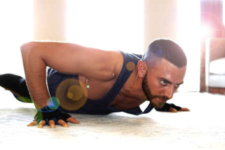 A young man make exercise at home