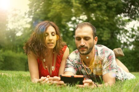 Couple of persons doing selfie in a park