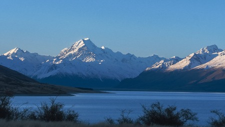 sun setting on mt cook and lake pukaki in new zealand