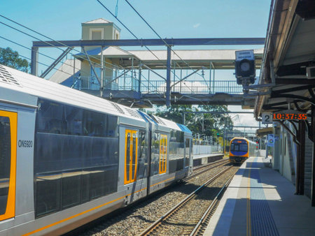 WYONG, AUSTRALIA - APRIL 7 2015: a commuter train passes another train waiting at a station in nsw australiaのeditorial素材