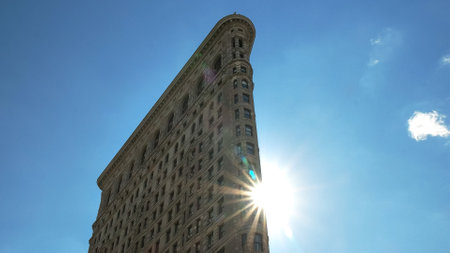 NEW YORK, NEW YORK, USA - SEPTEMBER 14, 2015: close up of the sun and the flatiron building, new...