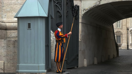 VATICAN STATE- SEPTEMBER 30, 2015: side view of a swiss guard at saint peters square, romeのeditorial素材