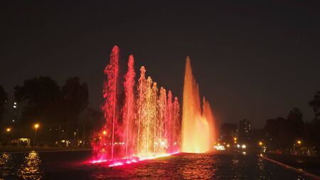 red lighting on the magic water circuit fountain in limaの写真素材