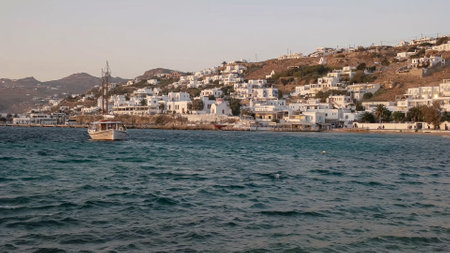 MYKONOS, GREECE- SEPTEMBER, 13, 2016: wide view of a sailing boat and the harbor at chora, mykonosのeditorial素材