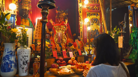 HONG KONG, CHINA- OCTOBER, 2, 2017: female worshiper praying at man mo temple in hong kongのeditorial素材