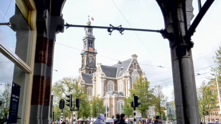AMSTERDAM, NETHERLANDS-OCTOBER, 12, 2017: wide view of westerkerk framed by an archway in amsterdamのeditorial素材