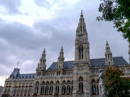 VIENNA, AUSTRIA, OCTOBER, 9, 2017 an exterior view of rathaus and a statue at dusk in viennaのeditorial素材