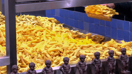 close up of a worker scooping fried potato chips in amsterdamのeditorial素材