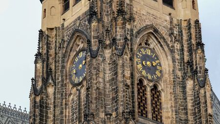 close up of the clock tower in prague castleの写真素材
