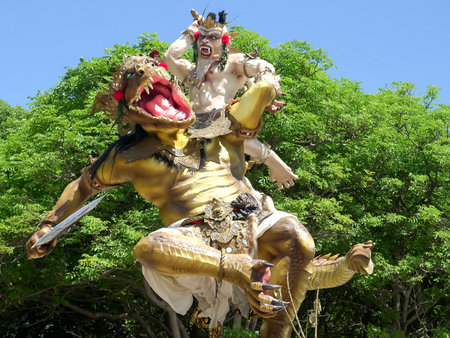 KUTA, INDONESIA - MARCH, 16, 2018: ogoh-ogoh statue in front of trees at kuta beach on baliのeditorial素材