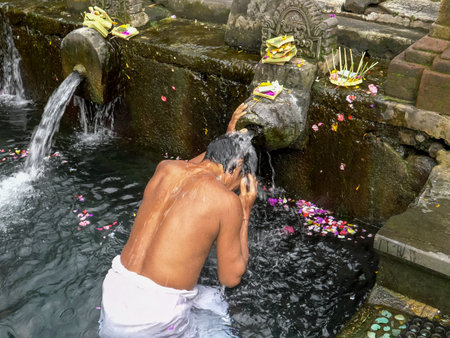 hindu worshipers bath at holy water temple on baliのeditorial素材