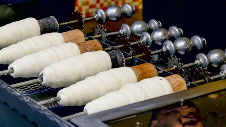 close view of raw trdelnik cooking in prague