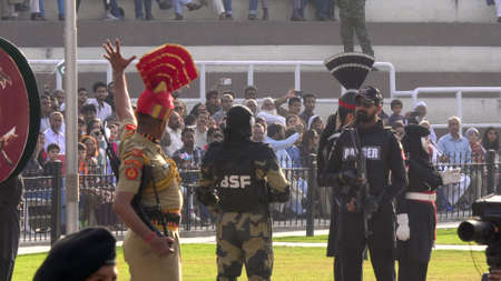 AMRITSAR, INDIA - MARCH 19, 2019: soldiers face off at the wagah border in indiaのeditorial素材