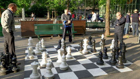 GENEVA, SWITZERLAND - JUNE, 7, 2019: player contemplating next move in an outdoor chess game in genevaのeditorial素材