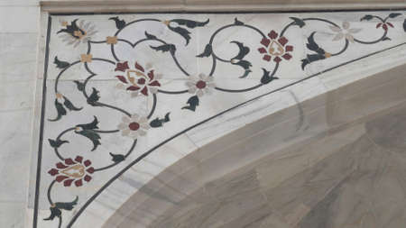 AGRA, INDIA - MARCH, 26, 2019: close up of floral decorations on the taj mahalのeditorial素材
