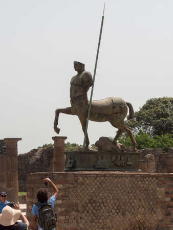 NAPLES, ITALY- JUNE, 13, 2019: modern art bronze statue of a centaur at the ruins of pompeiiのeditorial素材