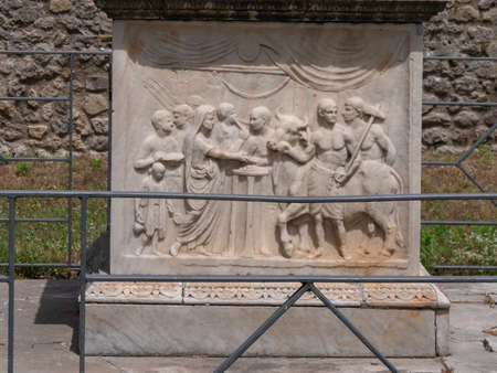 NAPLES, ITALY- JUNE, 13, 2019: marble altar with carved bas-relief, of a bull to be sacrificed, in the temple of vespasian at pompeiのeditorial素材