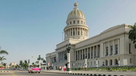 a pink convertible car driving past the capitolio buildingのeditorial素材