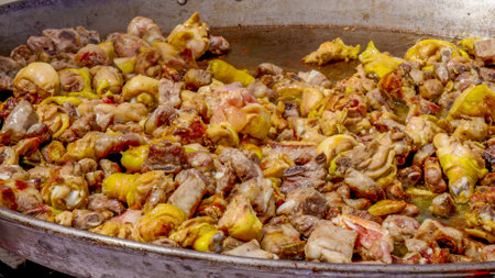 meat frying in a large paella pan for feast outside sagrada familiaの写真素材