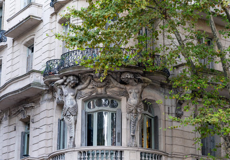 BUENOS AIRES, ARGENTINA- MARCH, 10, 2024: a shot of sculptures of two women beside a window on the front of a historic buildingのeditorial素材