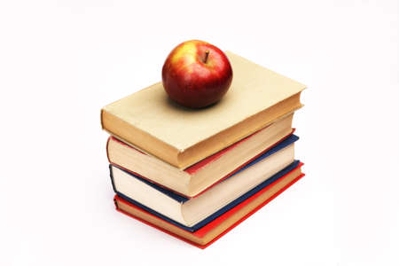 Pile of books with apple on topの写真素材