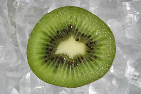 Kiwi fruit half on iceの写真素材