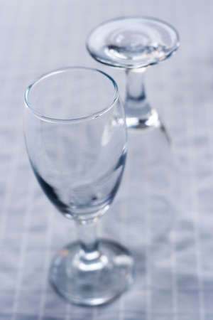 Two empty wine glasses on a white surfaceの写真素材
