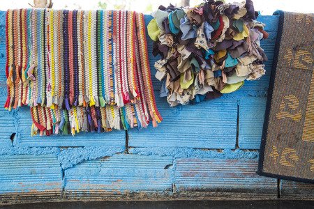 Colourful rugs draped on wallの写真素材