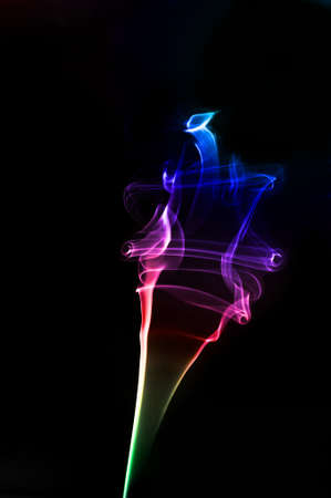 A colorful conceptual twirl of smoke with a rainbow effect の写真素材
