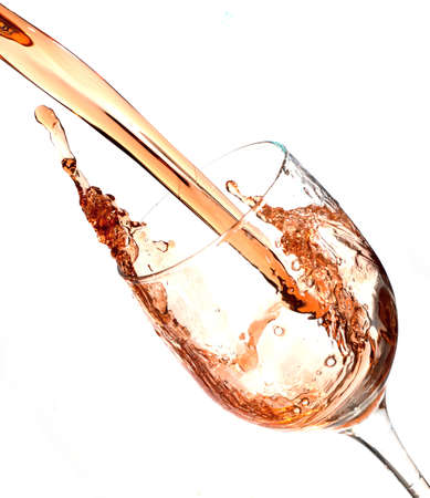 Wine being poured into a wine glass and caught in actionの写真素材