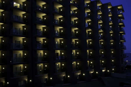 Lots of balconies lined up in the busy area of Torremolinos at nightの写真素材