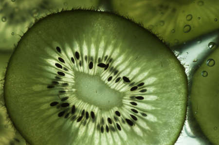 A fresh slice of kiwi ready to eatの写真素材