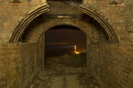 Photo taken from a tunnel capturing the lighthouseの写真素材