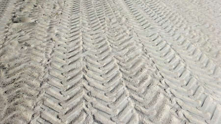 Tire tracks on the sand of the beach. Close-up.