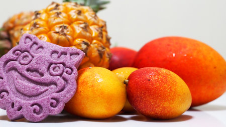 Brightly colored Okinawa tropical fruit and Shisa cookiesの写真素材