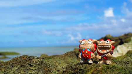 Okinawa's blue sea and smiling Shisas are Okinawa guardian lions. landscape photo copy spaceの写真素材