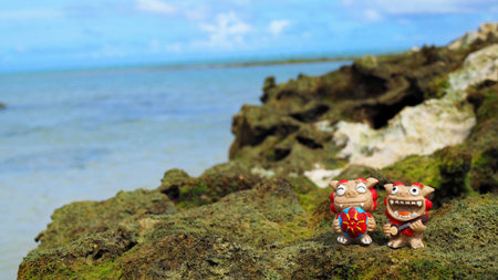 Okinawa's blue sea and smiling Shisas are Okinawa guardian lions. landscape photo copy spaceの写真素材
