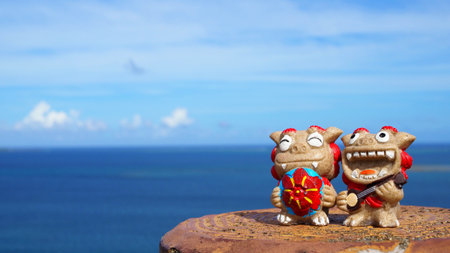 Okinawa's blue sea and smiling Shisas are Okinawa guardian lions. landscape photo copy space