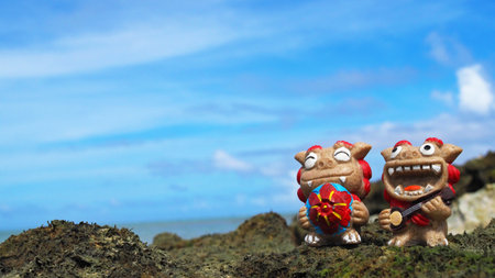 Okinawa's blue sea and smiling Shisas are Okinawa guardian lions. landscape photo copy spaceの写真素材