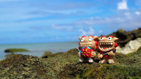 Okinawa's blue sea and smiling Shisas are Okinawa guardian lions. landscape photo copy spaceの写真素材