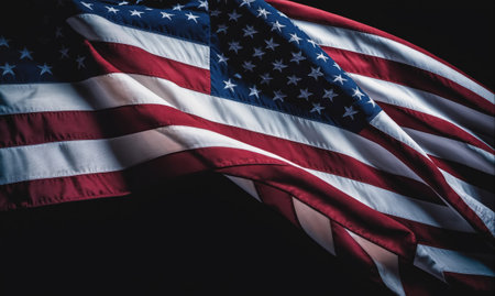 An American flag waves proudly against a dark backgroundの素材