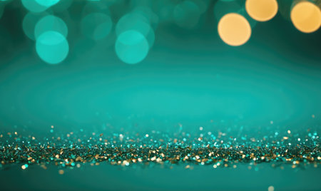 Golden and teal glitter sparkles on a dark teal background with blurry lightsの素材