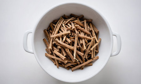 Dried sticks of Indian ginseng in a white bowlの素材